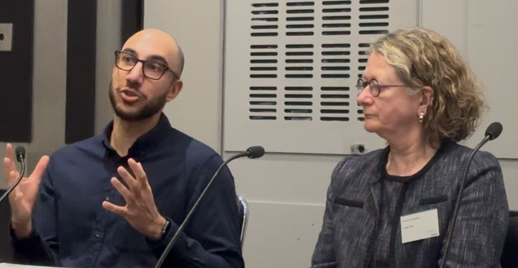 Image of Comms director at immigration summit gesticulating